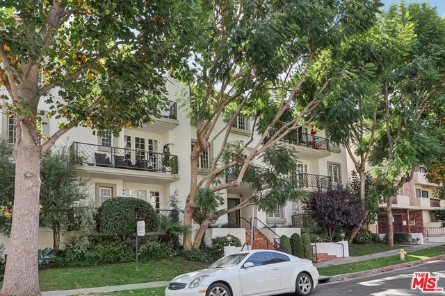 a view of a car parked in front of a building