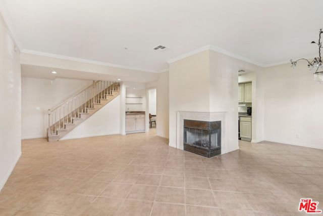 a view of an empty room with fire place and a fireplace