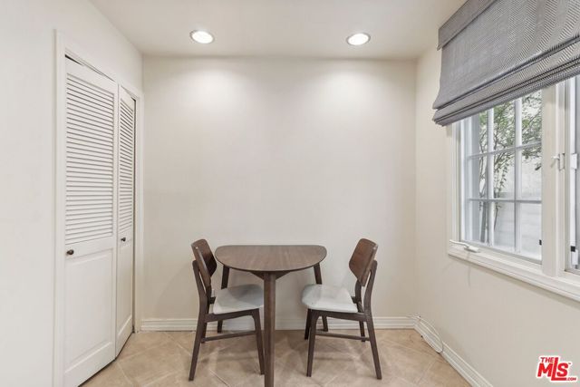 a dining room with furniture and a window
