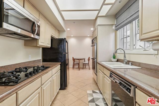 a kitchen with a sink a stove and refrigerator
