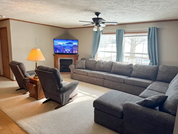a living room with furniture and a lamp