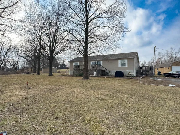 a view of a house with a yard covered in snow