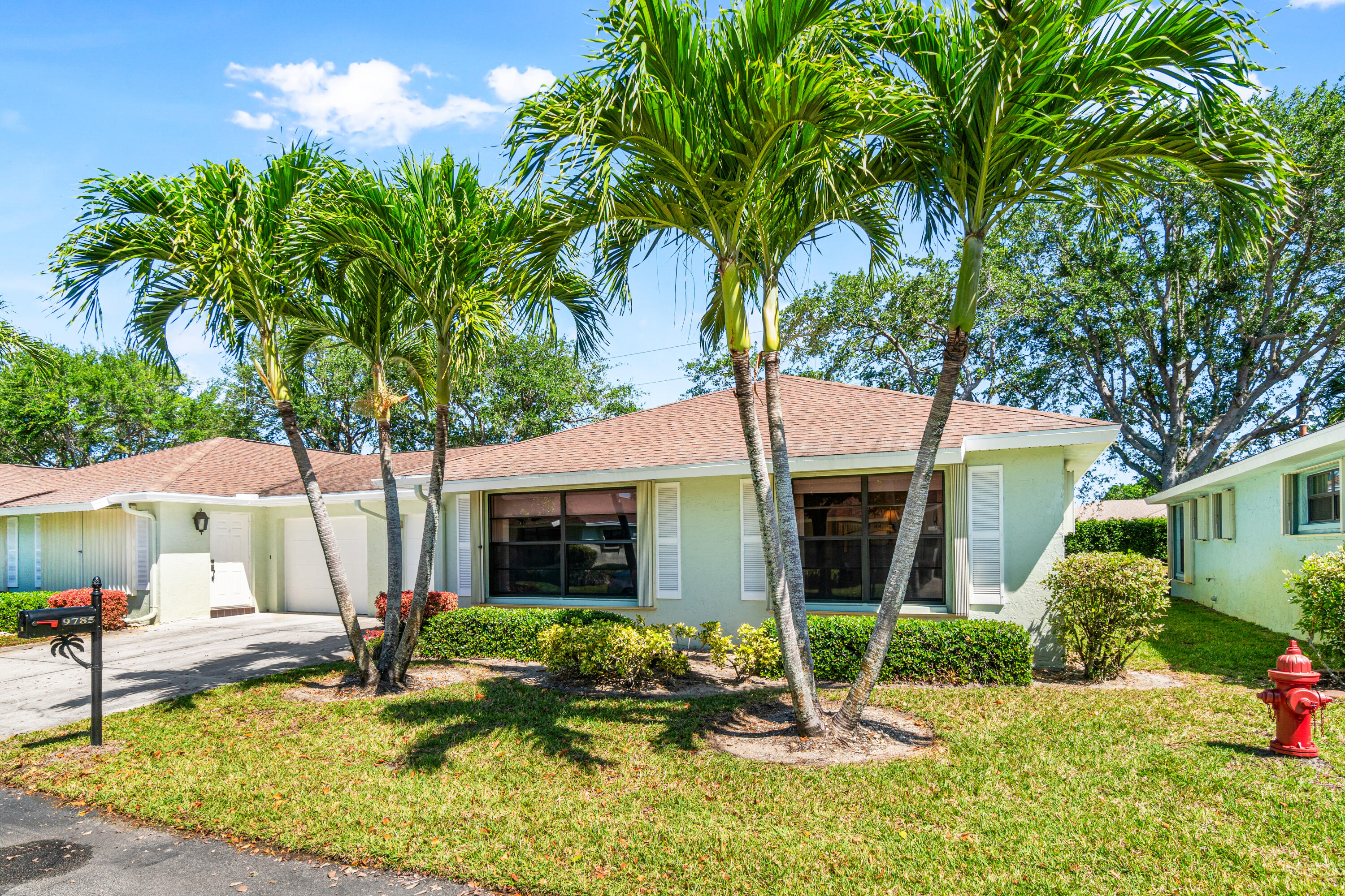 9785 Tabebuia Tree Drive, Unit B Boynton Beach, FL 33436 - Photo 1 of 30 a house view with a seating space and garden