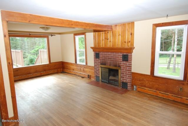 48 Interlaken Road Stockbridge, MA 01262 - Photo 5 of 37 a view of empty room with wooden floor and fireplace