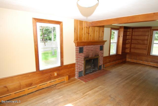 48 Interlaken Road Stockbridge, MA 01262 - Photo 6 of 37 a view of an empty room with a fireplace and a window
