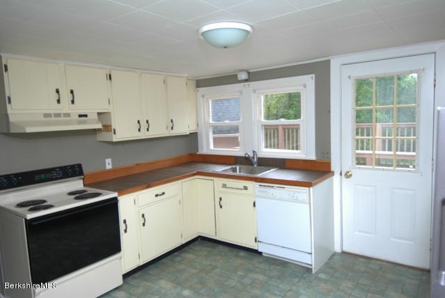 48 Interlaken Road Stockbridge, MA 01262 - Photo 7 of 37 a kitchen with granite countertop white cabinets and white appliances