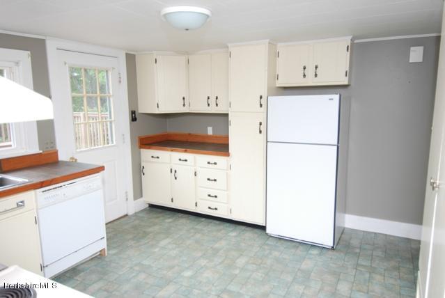 48 Interlaken Road Stockbridge, MA 01262 - Photo 8 of 37 a kitchen with cabinets appliances a sink and a window