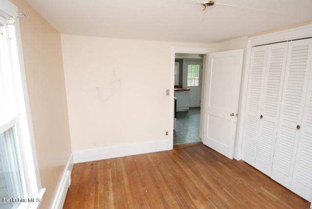 48 Interlaken Road Stockbridge, MA 01262 - Photo 10 of 37 an empty room with wooden floor and closet