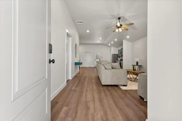 a view of a living room and kitchen with furniture