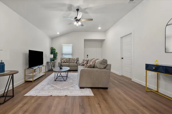 a living room with furniture and a flat screen tv