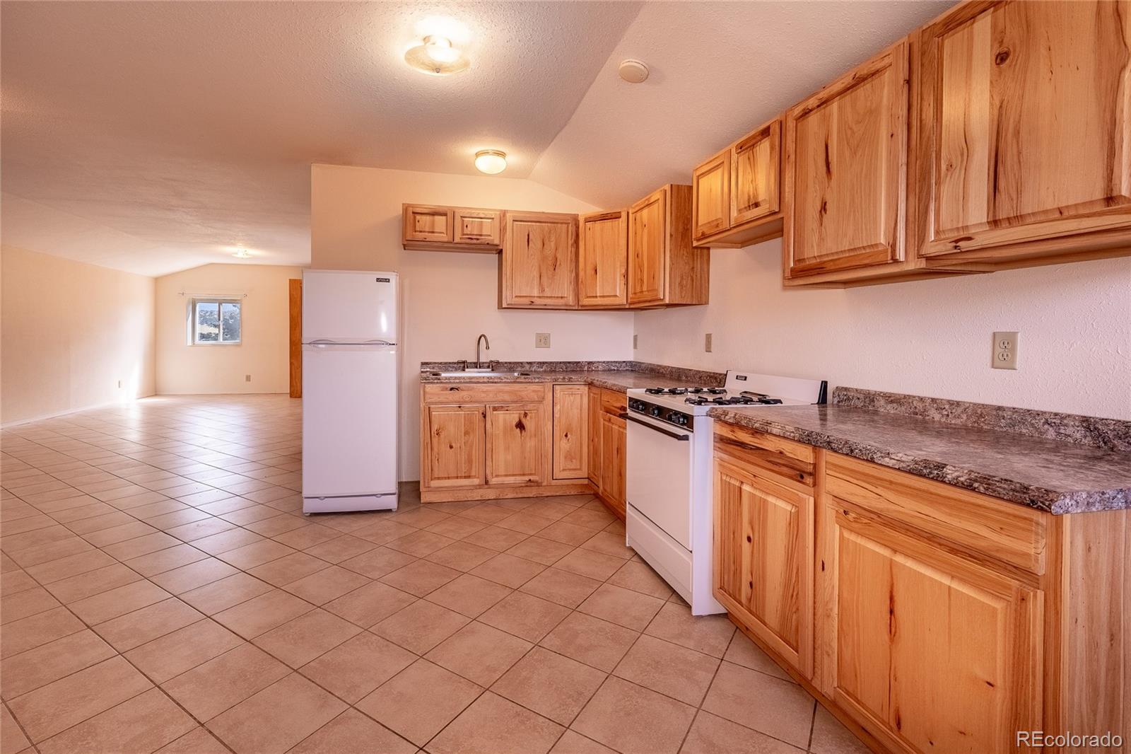 20622 Highway 69 Gardner, CO 81040 - Photo 6 of 33 a kitchen with stainless steel appliances granite countertop a stove a sink dishwasher and a refrigerator