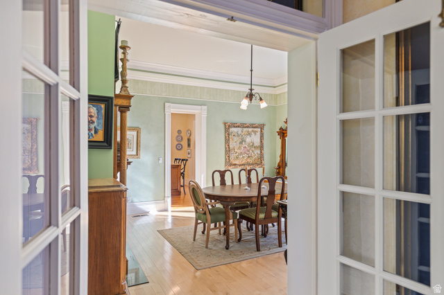 390 North 100 West Monroe, UT 84754 - Photo 17 of 167 Dining room featuring light wood-style floors, a chandelier, and ornamental molding