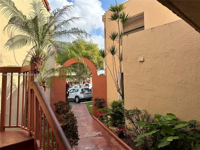 a couple of flower plants in front of door