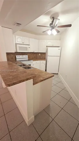 a kitchen with a sink cabinets and utility