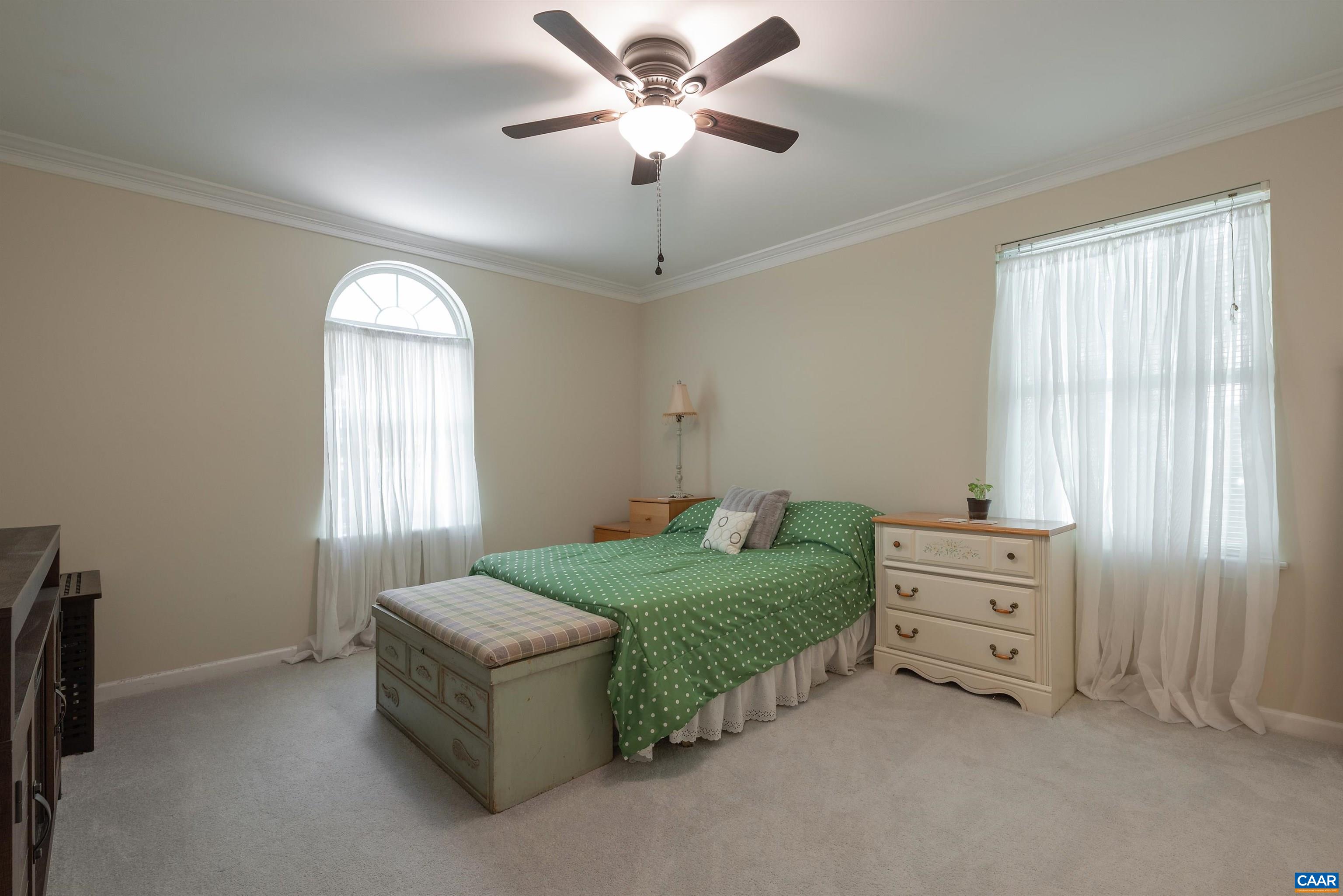23 Zephyr Road Palmyra, VA 22963 - Photo 12 of 26 a spacious bedroom with a bed and a chandelier