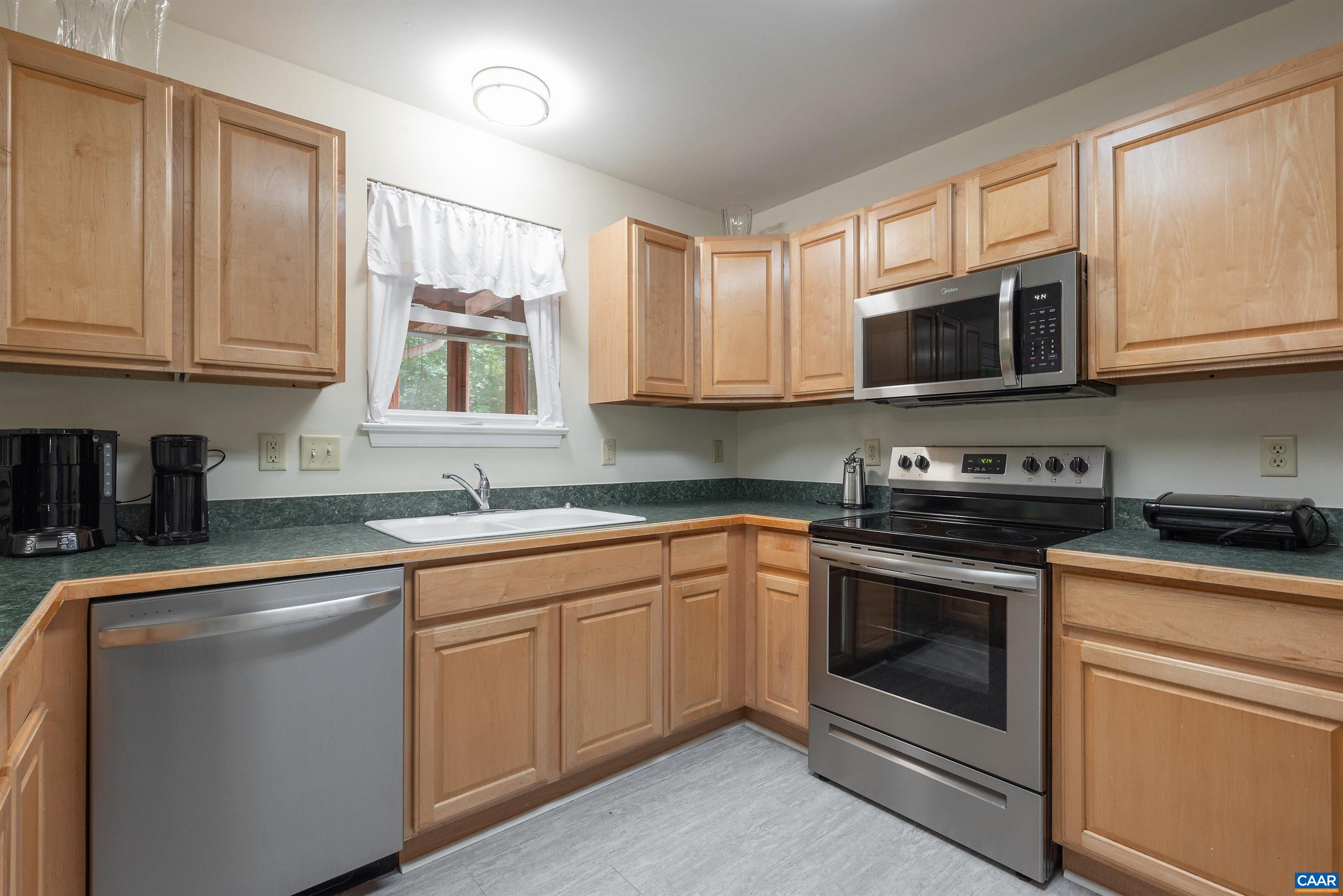 23 Zephyr Road Palmyra, VA 22963 - Photo 4 of 26 a kitchen with stainless steel appliances granite countertop grey cabinets a stove a sink and dishwasher
