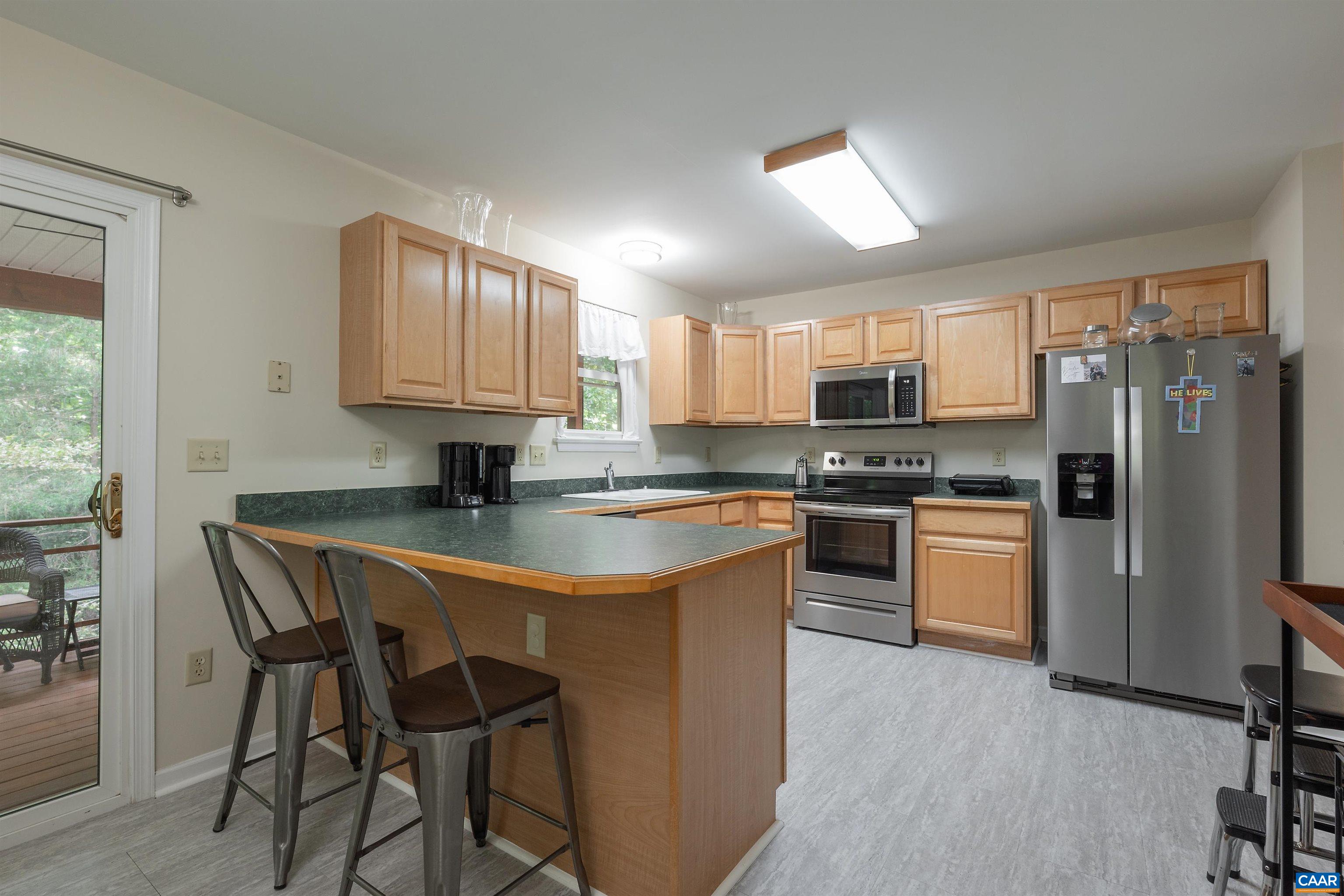 23 Zephyr Road Palmyra, VA 22963 - Photo 5 of 26 a kitchen with stainless steel appliances granite countertop white cabinets a refrigerator a stove a sink and a microwave