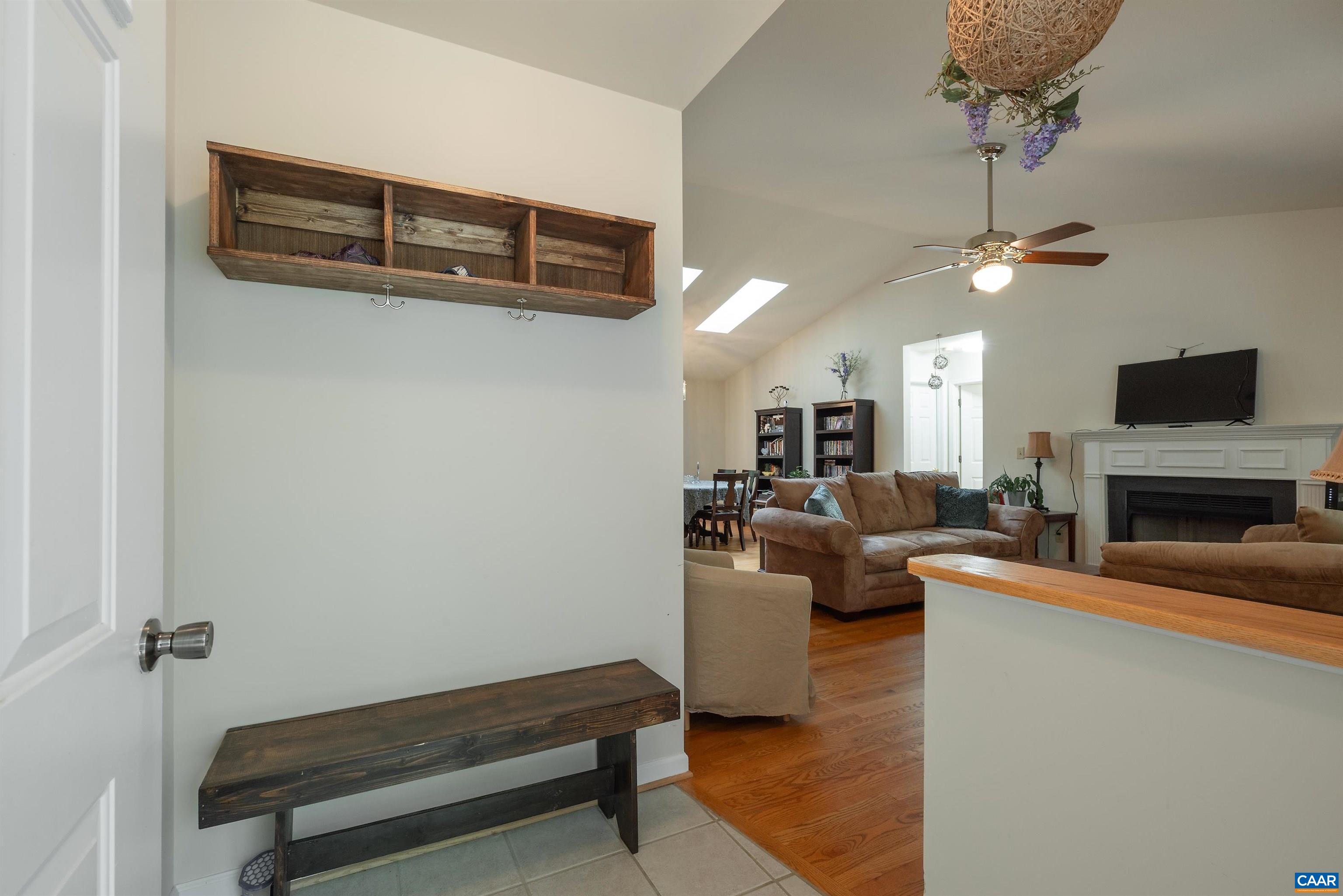 23 Zephyr Road Palmyra, VA 22963 - Photo 10 of 26 a living room with furniture a fireplace and a flat screen tv