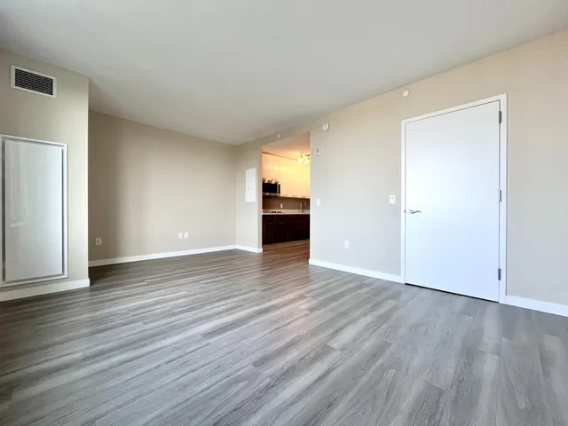 a view of an empty room and wooden floor