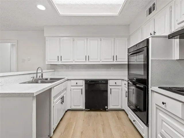 a kitchen with a sink stove and refrigerator