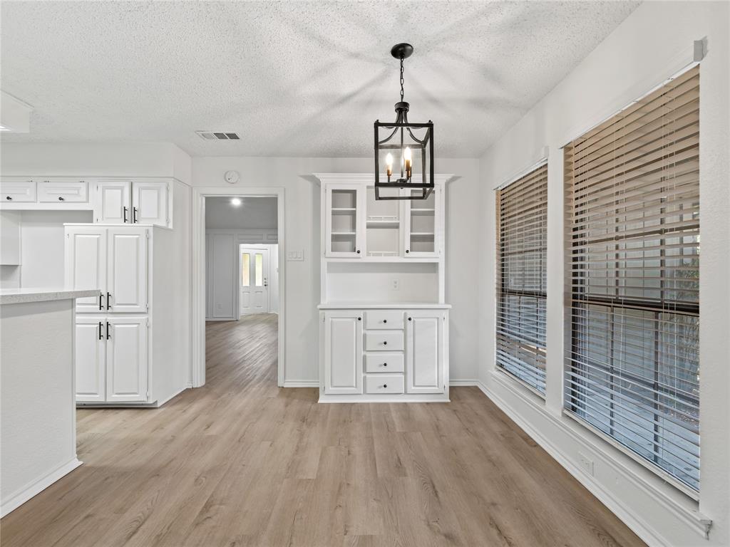 4028 St Christopher Lane Dallas, TX 75287 - Photo 17 of 29 a view of a hallway with wooden floor and staircase