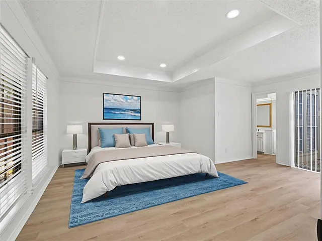 a bedroom with a large bed and a chandelier