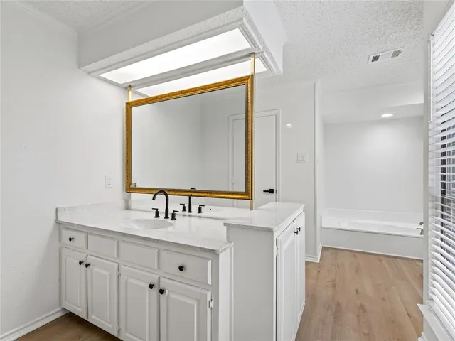 a bathroom with a double vanity sink mirror and