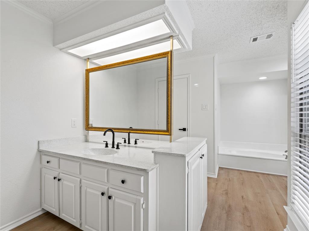 4028 St Christopher Lane Dallas, TX 75287 - Photo 23 of 29 a bathroom with a double vanity sink mirror and