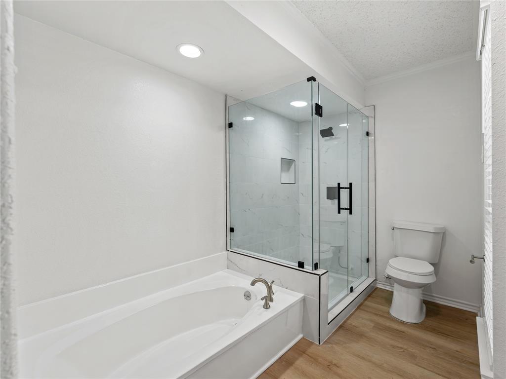 4028 St Christopher Lane Dallas, TX 75287 - Photo 25 of 29 a bathroom with a granite countertop sink a toilet and shower