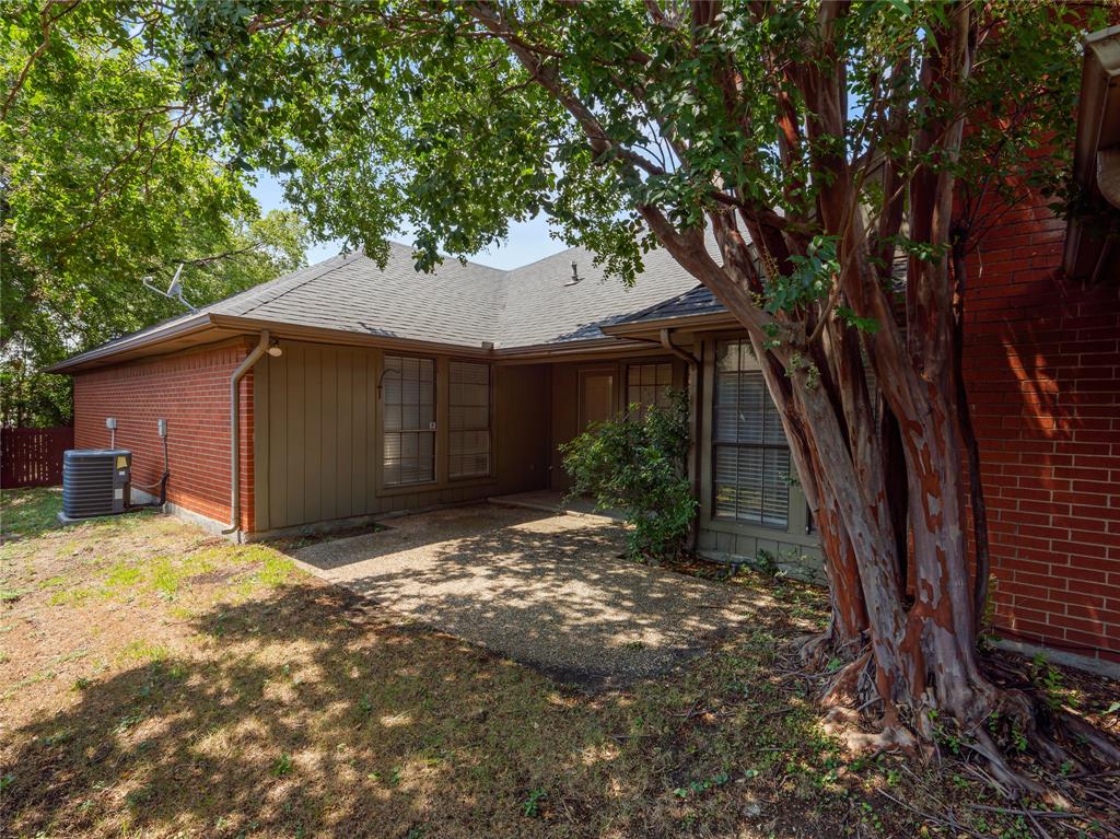 4028 St Christopher Lane Dallas, TX 75287 - Photo 27 of 29 a view of a house with a yard tree and wooden fence