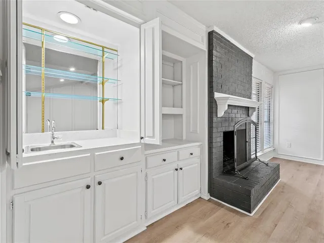 a kitchen with cabinets and a fireplace