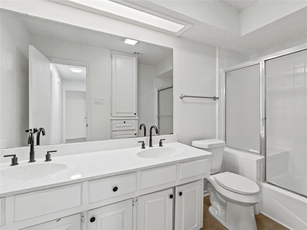 4028 St Christopher Lane Dallas, TX 75287 - Photo 9 of 29 a bathroom with a sink toilet and shower