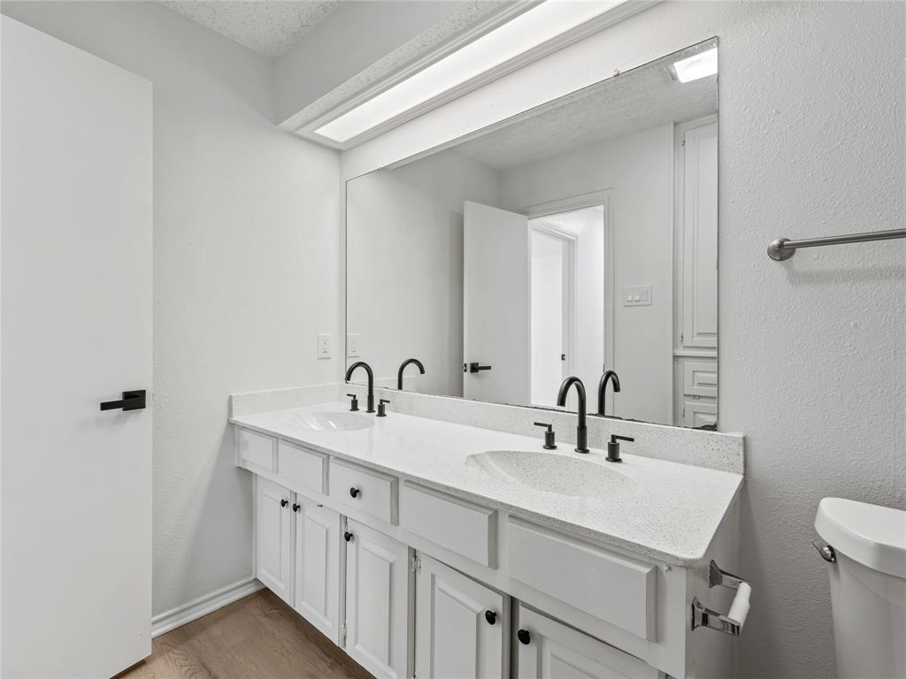 4028 St Christopher Lane Dallas, TX 75287 - Photo 10 of 29 a bathroom with a sink and a mirror