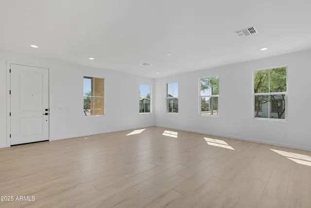 an empty room with windows and closet