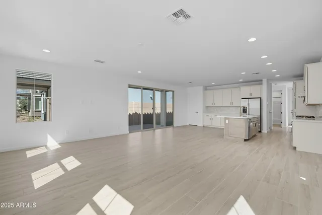 a view of an empty room with glass door