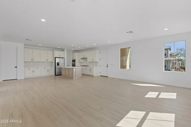 a view of kitchen with center island and stainless steel appliances