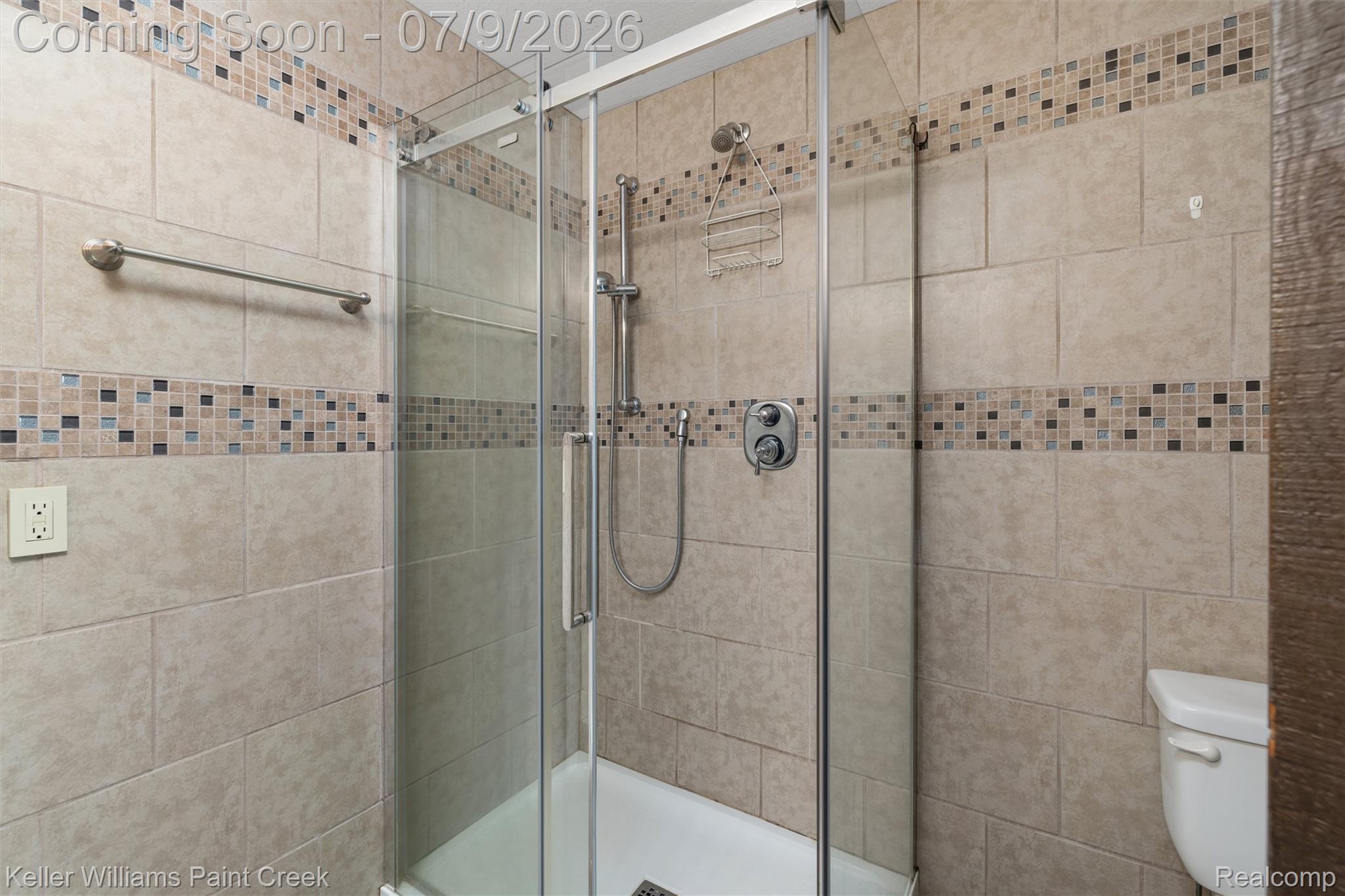 28780 School Section Road Richmond, MI 48062 - Photo 26 of 50 Enclosed shower with clear glass door, featuring neutral-toned tile walls and a mosaic tile accent band