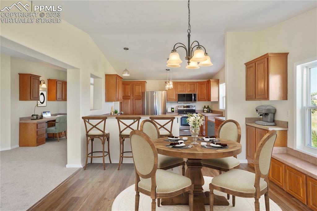 12825 Mc Cune Road Elbert, CO 80106 - Photo 13 of 50 a view of a dining room with furniture a kitchen and chandelier