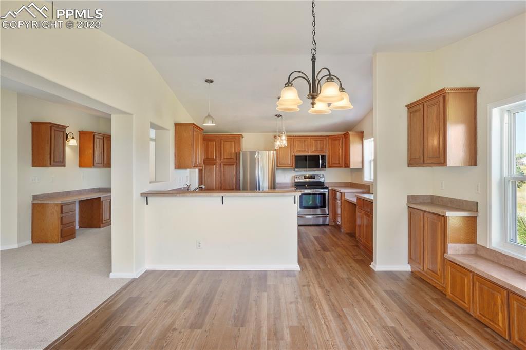 12825 Mc Cune Road Elbert, CO 80106 - Photo 14 of 50 a view of a kitchen with cabinets stainless steel appliances and wooden floor