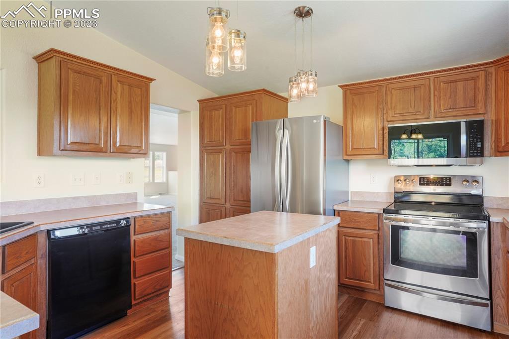 12825 Mc Cune Road Elbert, CO 80106 - Photo 15 of 50 a kitchen with stainless steel appliances kitchen island granite countertop a stove a refrigerator and a sink