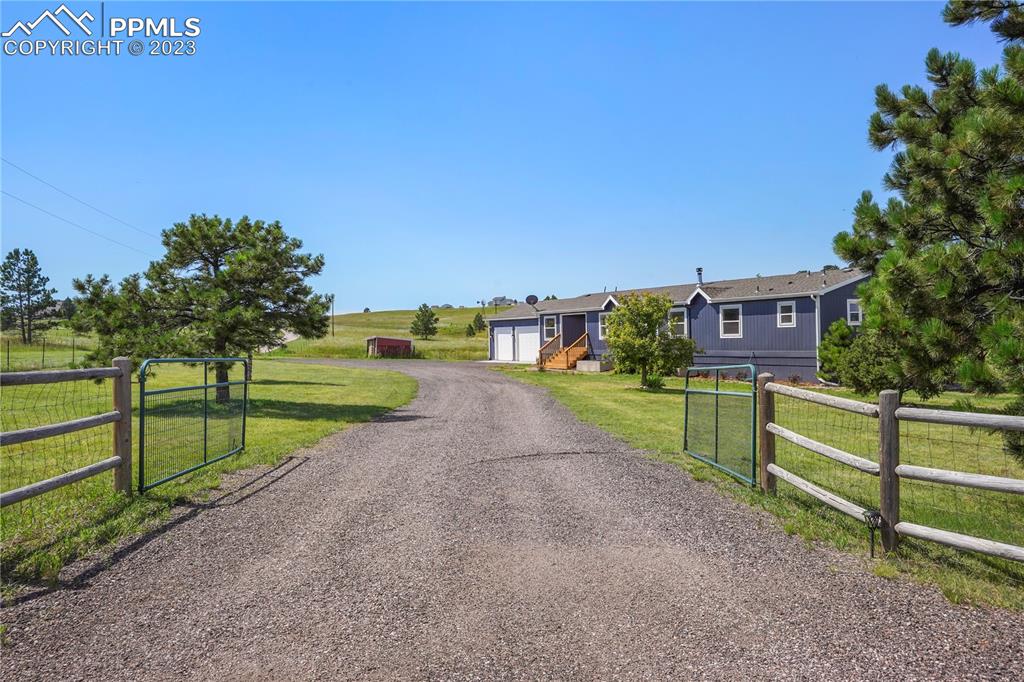 12825 Mc Cune Road Elbert, CO 80106 - Photo 2 of 50 a view of street with wooden fence