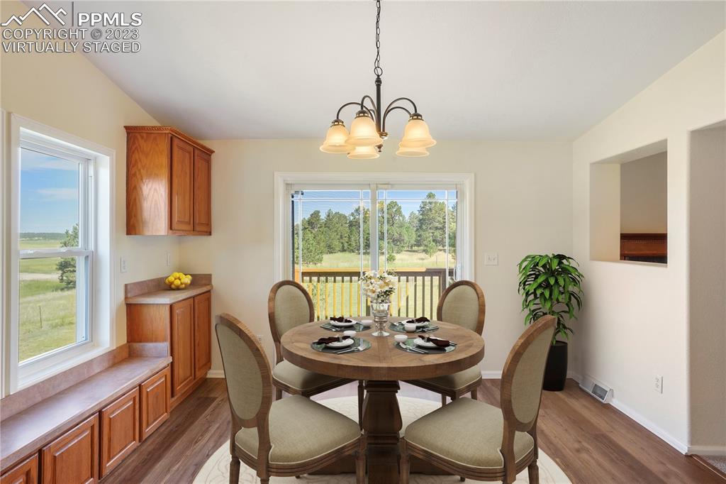 12825 Mc Cune Road Elbert, CO 80106 - Photo 21 of 50 a view of a dining room with furniture window and wooden floor