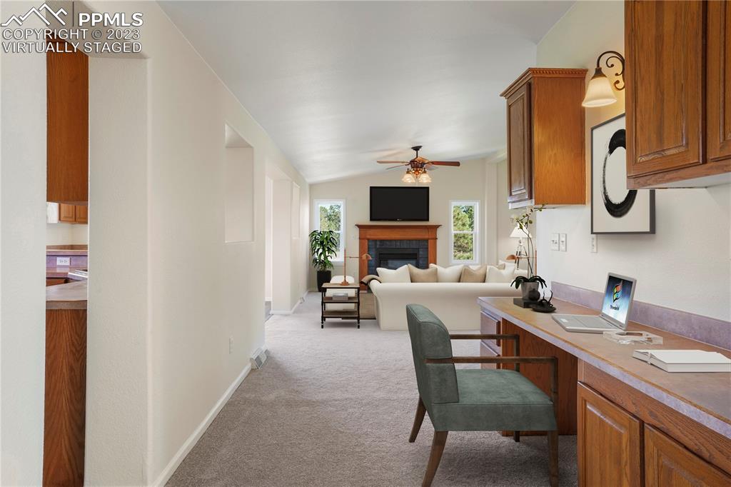 12825 Mc Cune Road Elbert, CO 80106 - Photo 24 of 50 a living room with furniture a fireplace and a flat screen tv