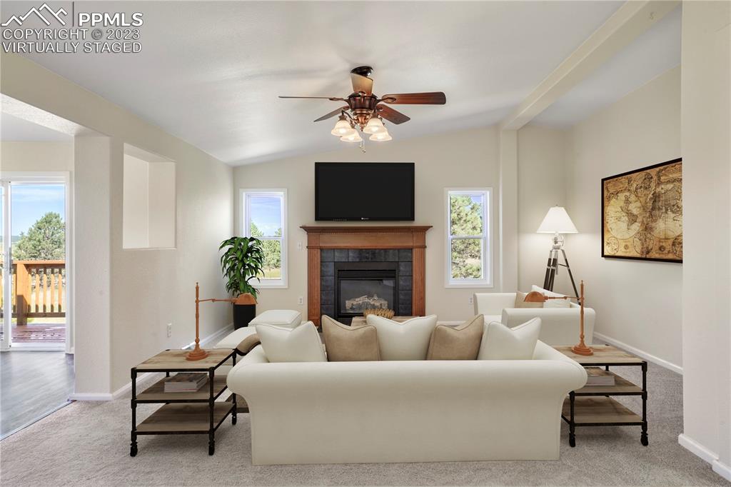 12825 Mc Cune Road Elbert, CO 80106 - Photo 26 of 50 a living room with furniture a fireplace and a flat screen tv