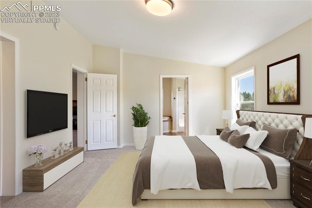 12825 Mc Cune Road Elbert, CO 80106 - Photo 29 of 50 a bedroom with a bed and a flat screen tv