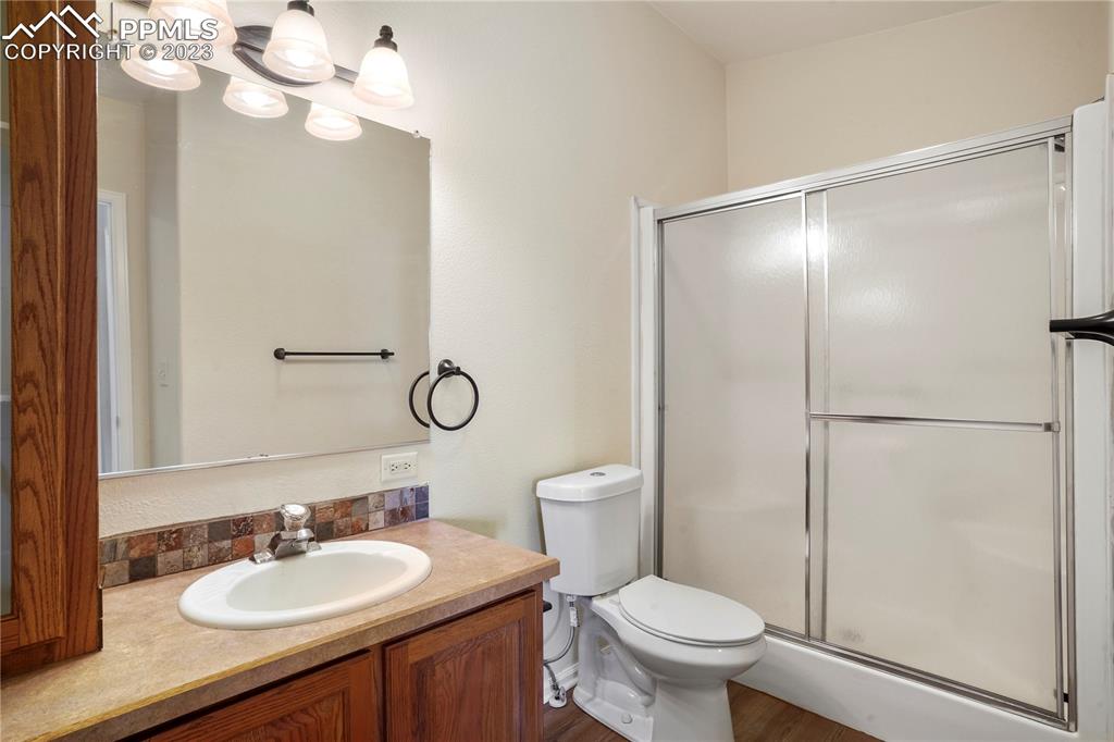 12825 Mc Cune Road Elbert, CO 80106 - Photo 38 of 50 a bathroom with a toilet a sink a mirror and vanity