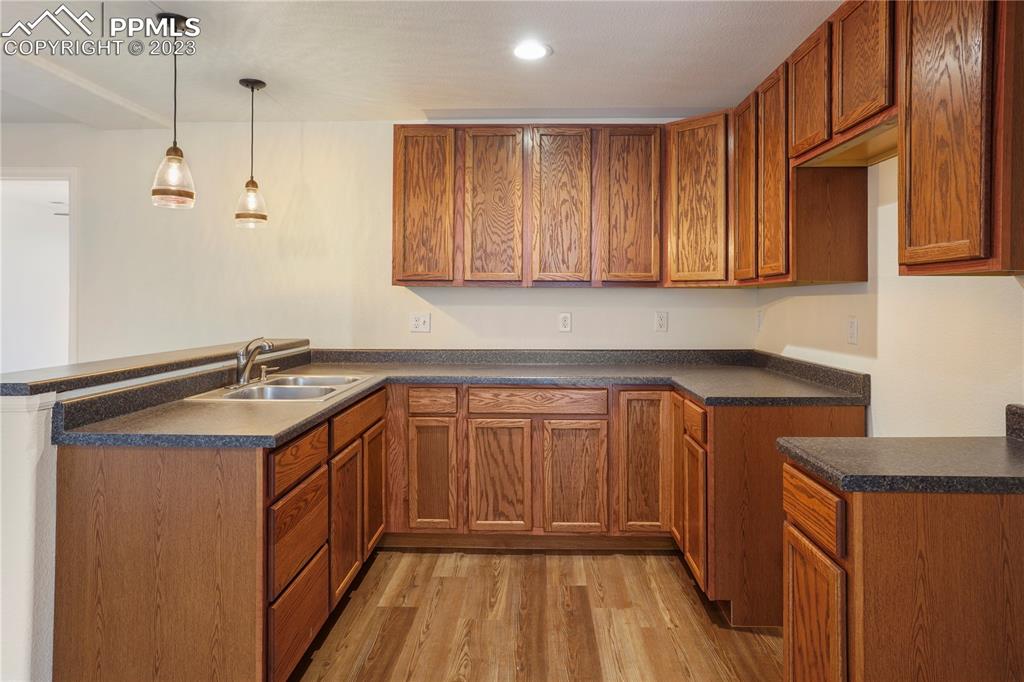 12825 Mc Cune Road Elbert, CO 80106 - Photo 44 of 50 a kitchen with a sink cabinets and wooden floor