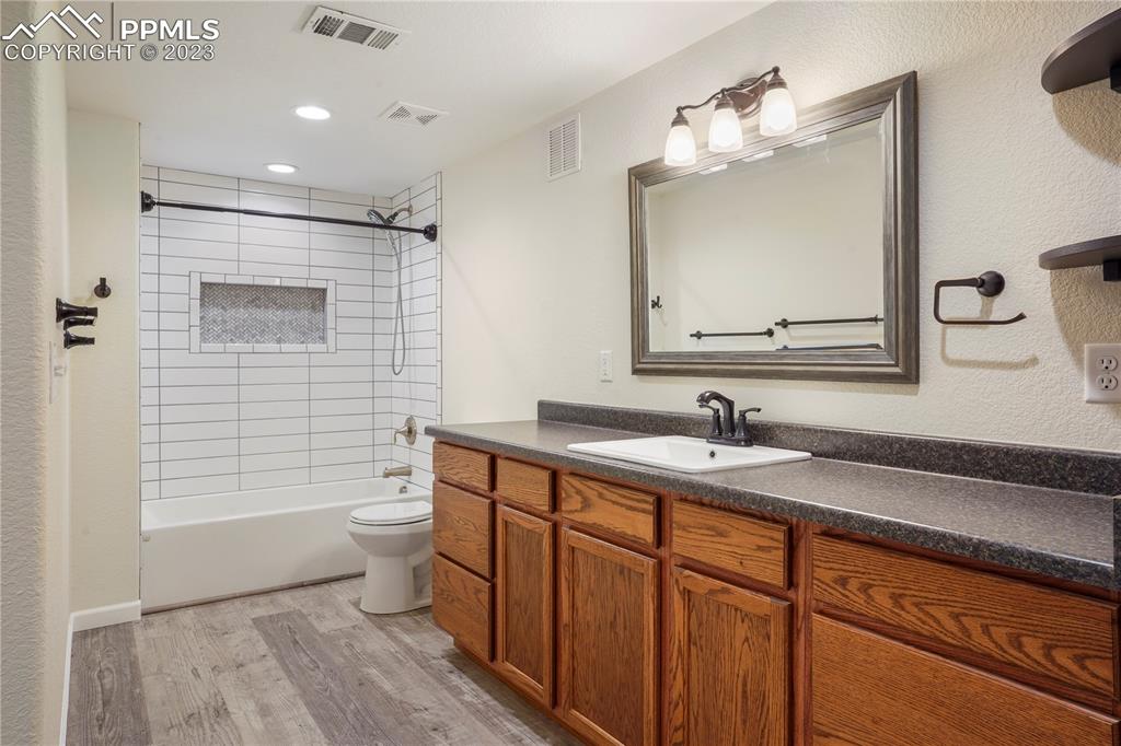 12825 Mc Cune Road Elbert, CO 80106 - Photo 47 of 50 a bathroom with a toilet a sink a mirror a shower a vanity and window