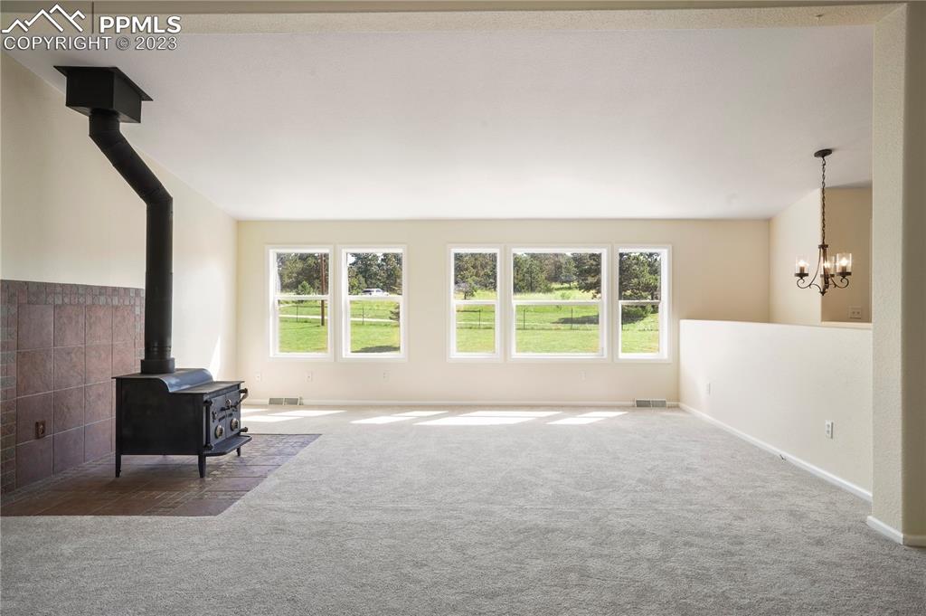 12825 Mc Cune Road Elbert, CO 80106 - Photo 10 of 50 a spacious bedroom with a bed and wooden floor