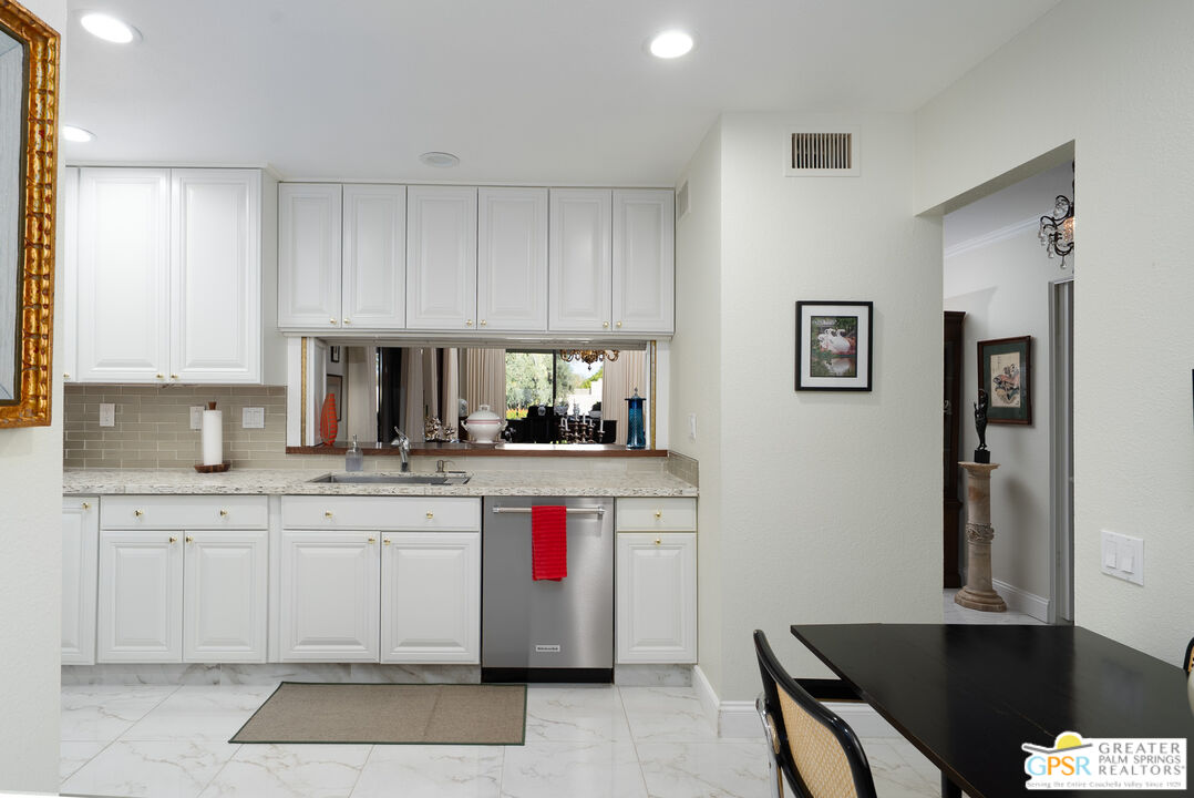 1142 East La Jolla Road Palm Springs, CA 92264 - Photo 13 of 35 a kitchen with a sink cabinets and window